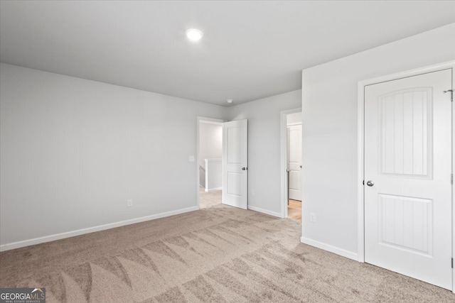 unfurnished bedroom with light colored carpet