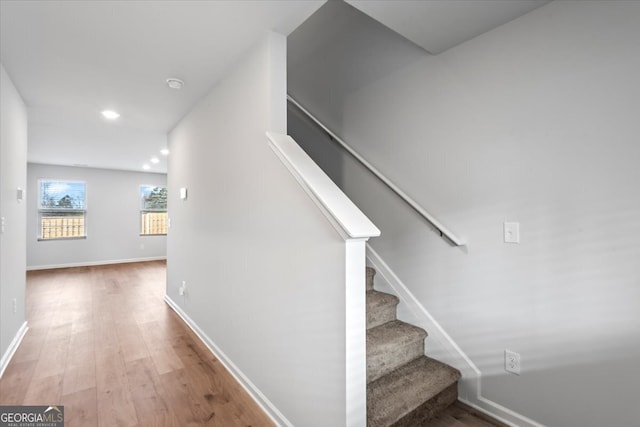 staircase with hardwood / wood-style flooring