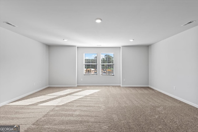 unfurnished room featuring light carpet