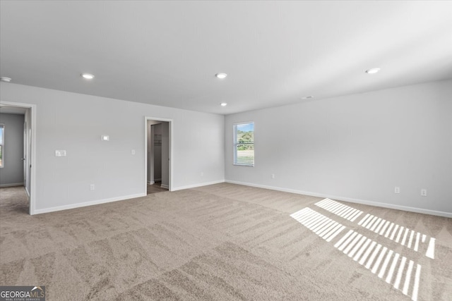 spare room featuring light colored carpet