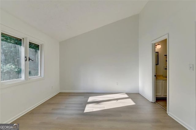 interior space featuring vaulted ceiling and hardwood / wood-style flooring