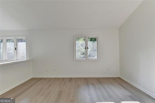 spare room featuring light wood-type flooring