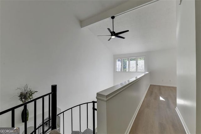 hallway with vaulted ceiling with beams and hardwood / wood-style floors