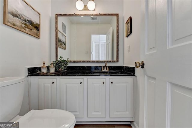 bathroom featuring vanity and toilet