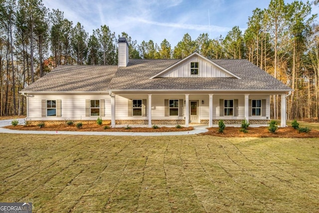 view of front of house with a porch and a front lawn