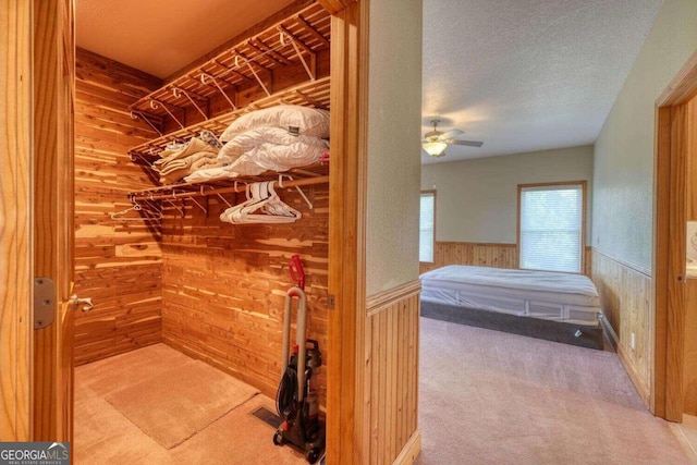 spacious closet featuring ceiling fan and carpet floors