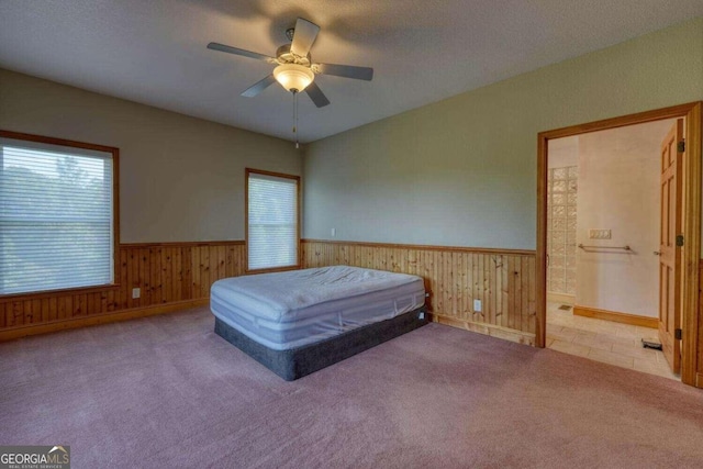 unfurnished bedroom featuring ceiling fan, a textured ceiling, and carpet