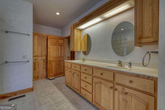 bathroom featuring dual vanity and tile patterned flooring