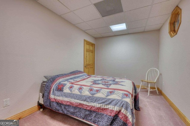 bedroom featuring a paneled ceiling and carpet floors