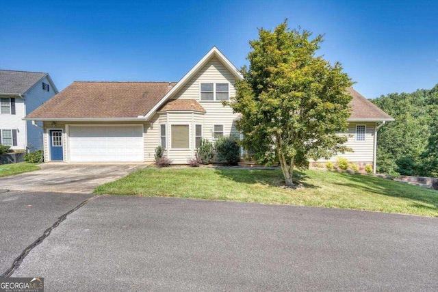 view of front of property with a front yard and a garage