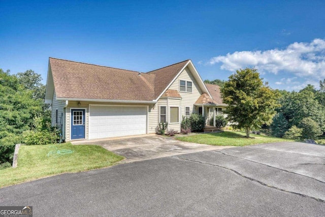 view of front of property with a front lawn and a garage