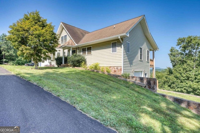 view of side of home with a lawn