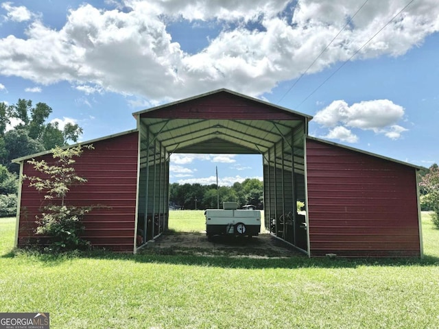 view of outbuilding featuring a carport and a yard