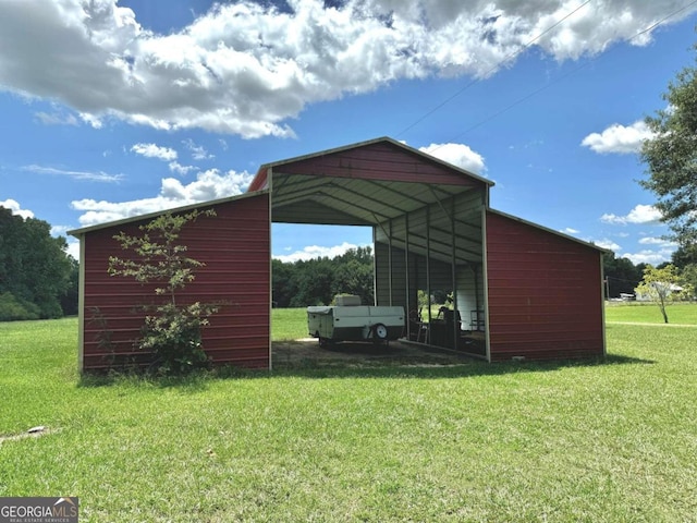 view of outbuilding with a carport and a yard