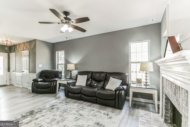 living room featuring ceiling fan and light wood-type flooring