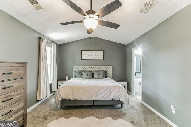 carpeted bedroom featuring vaulted ceiling, ceiling fan, and a textured ceiling