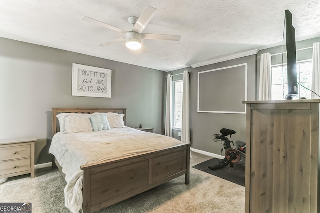 carpeted bedroom featuring ceiling fan and a textured ceiling