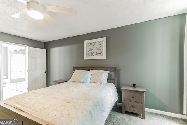 carpeted bedroom featuring a textured ceiling and ceiling fan