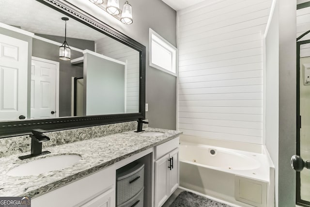 bathroom with vanity and a washtub