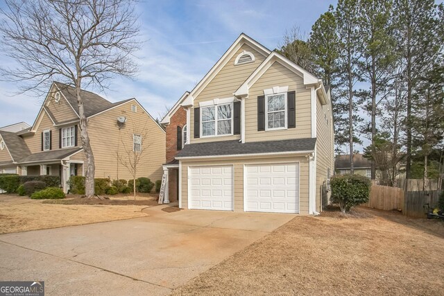 view of front of property with a garage and a yard