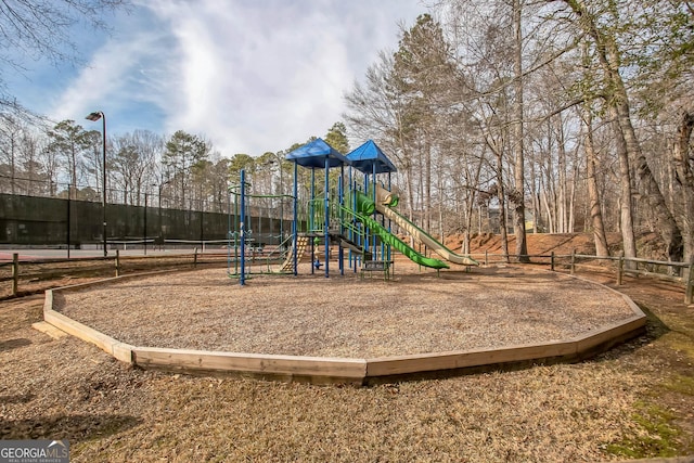 view of jungle gym with tennis court