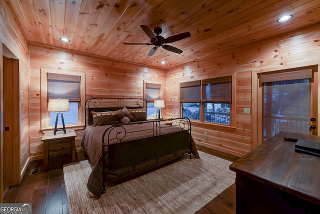 bedroom featuring wood-type flooring, wooden walls, and wood ceiling