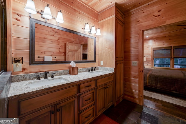 bathroom with wood walls, double sink vanity, and wood ceiling