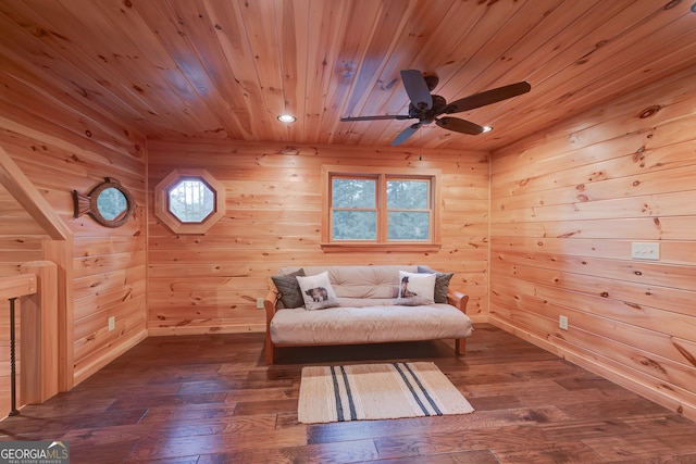 unfurnished room featuring wooden ceiling, ceiling fan, wood walls, and wood-type flooring