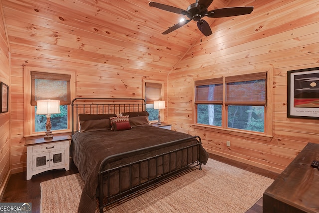 bedroom with ceiling fan, wooden walls, lofted ceiling, and hardwood / wood-style floors