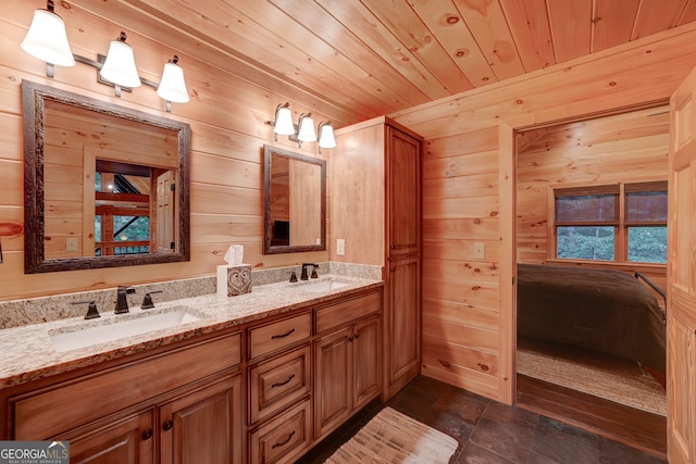 bathroom featuring dual bowl vanity, tile patterned floors, wood walls, and wooden ceiling