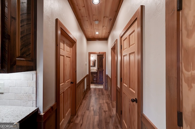 hallway featuring wood-type flooring and wood ceiling