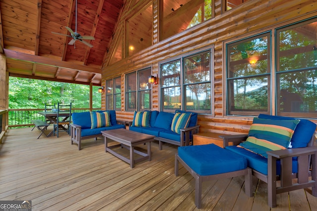 wooden deck featuring ceiling fan and an outdoor living space