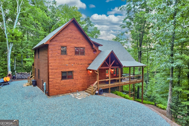 rear view of property featuring a deck