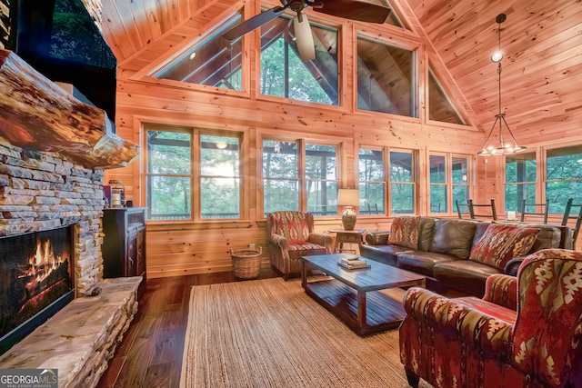 living room with a fireplace, a healthy amount of sunlight, and wooden ceiling