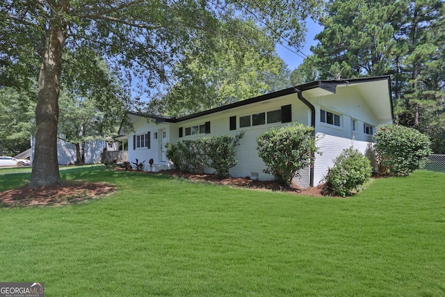 view of front of property featuring crawl space, a front lawn, and brick siding