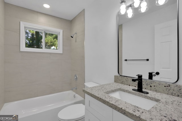 full bathroom featuring toilet, vanity, and tiled shower / bath