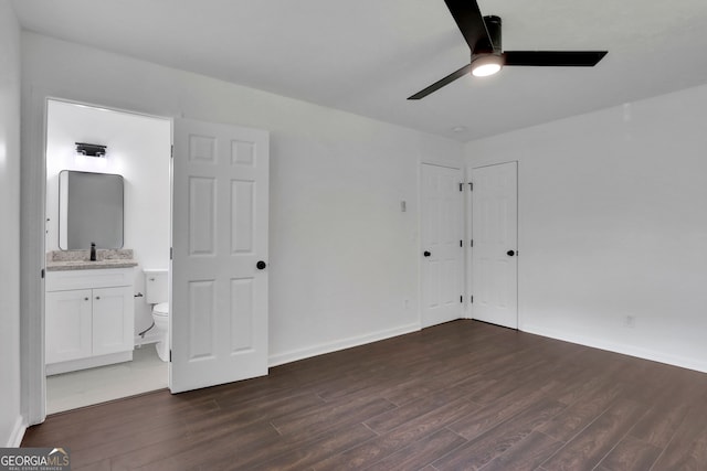 unfurnished bedroom featuring ensuite bath, sink, hardwood / wood-style flooring, and ceiling fan