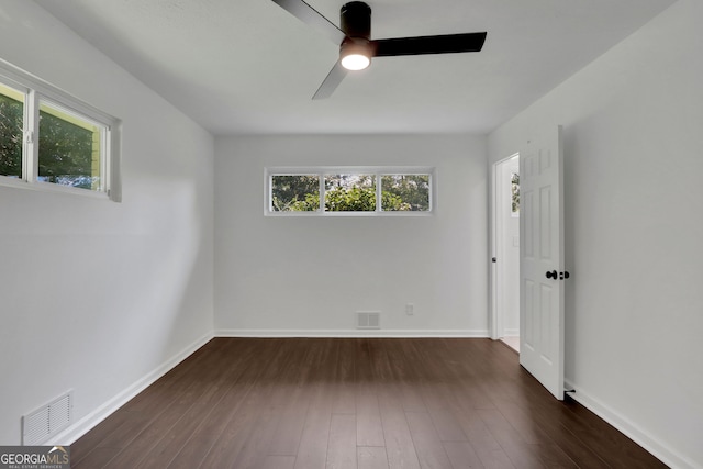 unfurnished room with ceiling fan and dark hardwood / wood-style floors