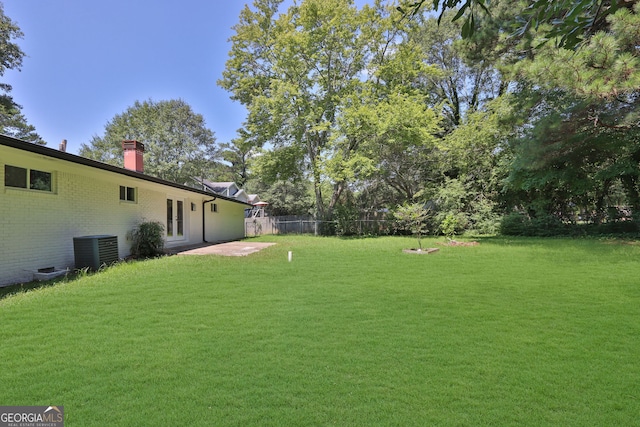 view of yard with central AC unit and a patio area