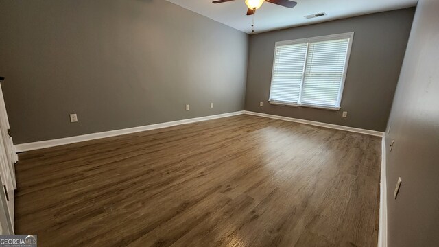 empty room with ceiling fan and hardwood / wood-style floors