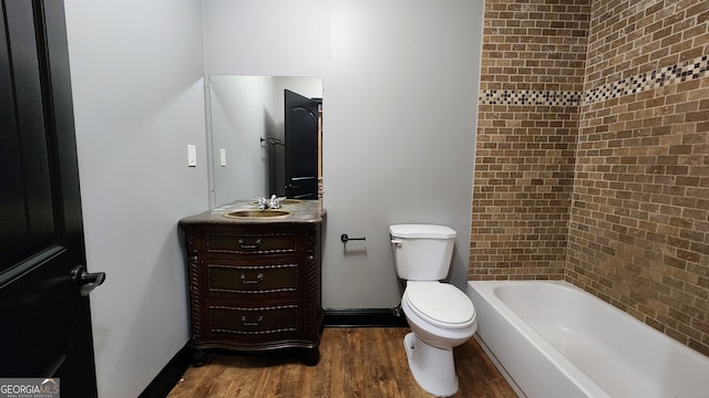 full bathroom featuring toilet, tiled shower / bath combo, vanity, and hardwood / wood-style flooring