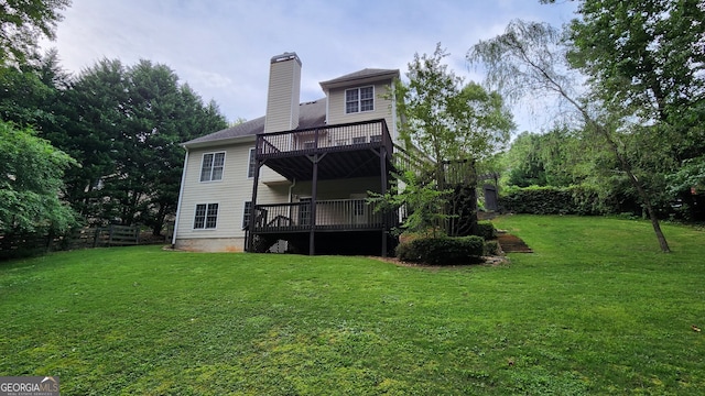 back of property with a yard and a deck