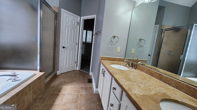 bathroom featuring double sink vanity, tile patterned flooring, and independent shower and bath