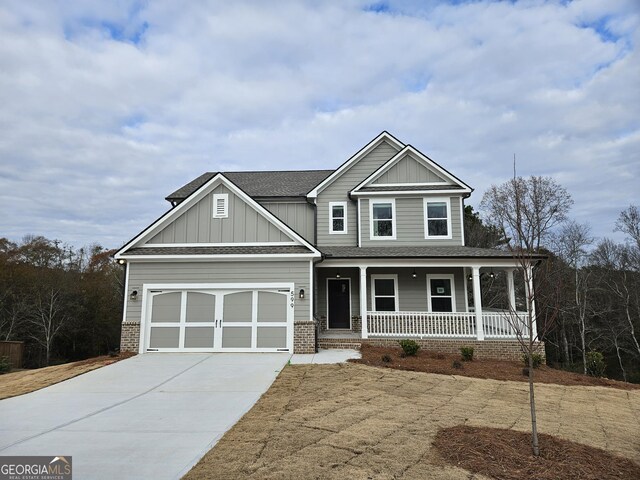 view of front of home featuring covered porch and a garage