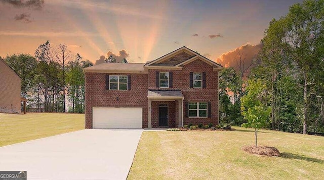 view of front of property featuring a lawn and a garage