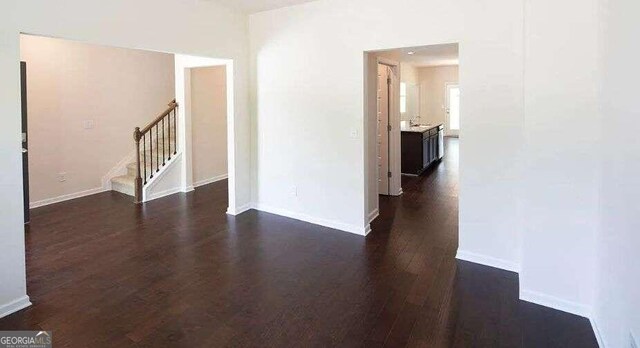 empty room featuring dark wood-type flooring