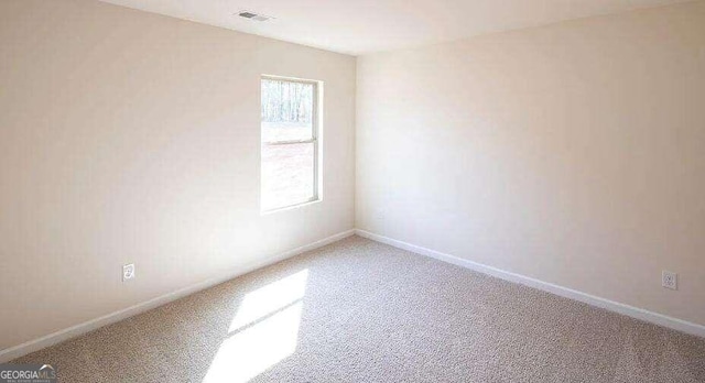 spare room featuring carpet flooring