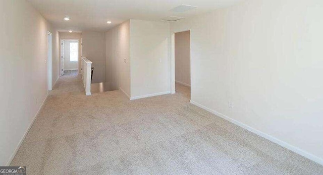 spare room with light carpet