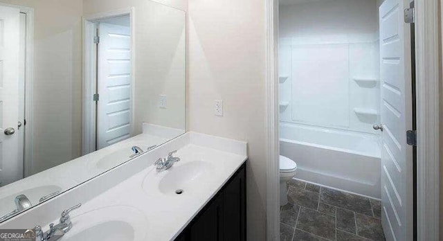 full bathroom with shower / tub combination, dual vanity, toilet, and tile patterned flooring