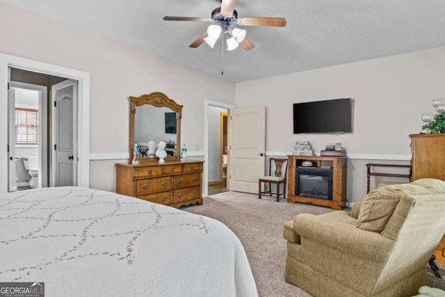 225 Big Oconee River Rd, Sparta, GA 31087 - bedroom featuring carpet, ceiling fan, a textured ceiling, and a glass covered fireplace